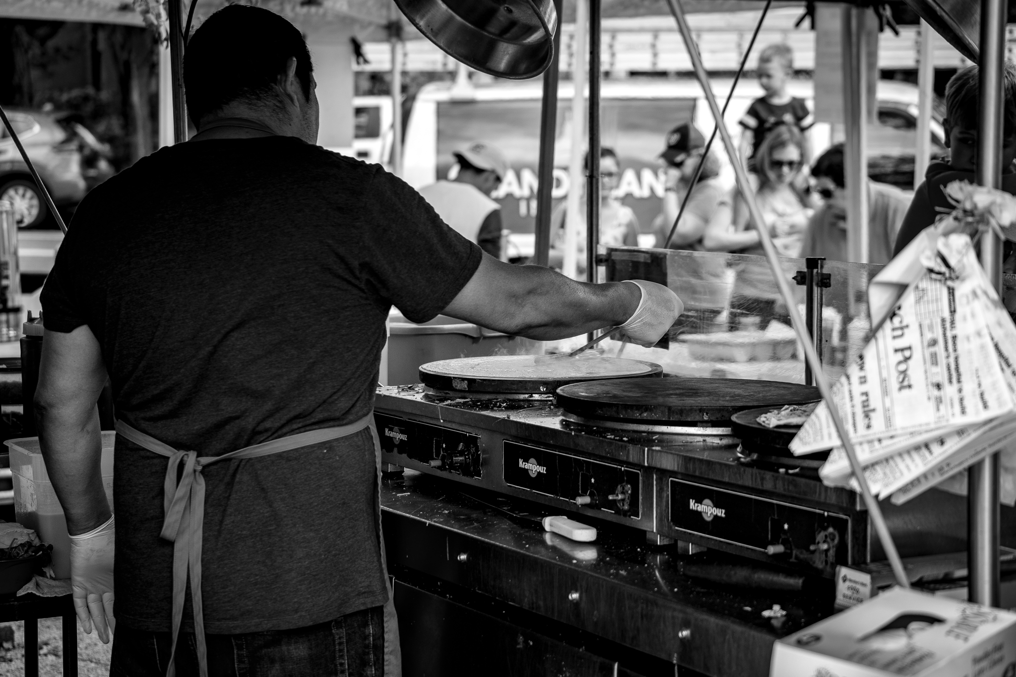 Food Vendor Busy Making Crepes by John Brighenti